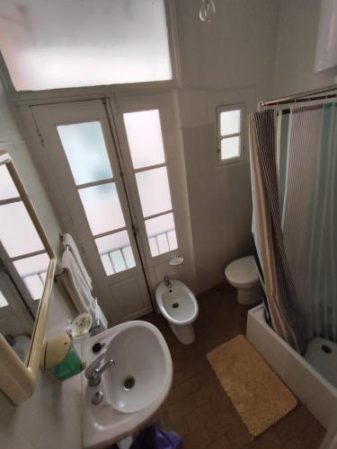 a bathroom with a sink and a toilet and windows at Porto Chique AL 4 in Porto