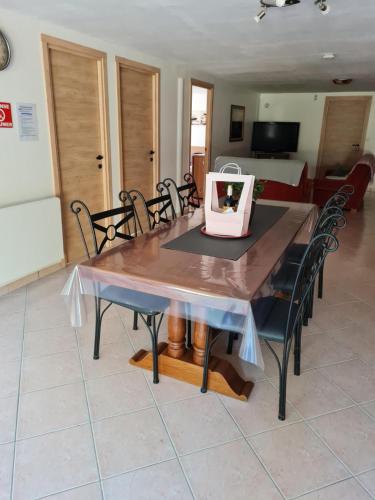 a dining room table with chairs and a bag on it at L occitane in Gimont