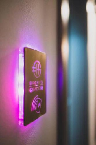 a lightswitch with a purple light on a wall at Hotel Gradche in Kochani