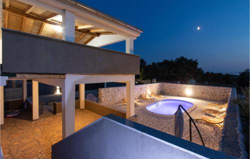a backyard with a hot tub on a patio at 5 Bedroom Gorgeous Home In Podlug in Podlug