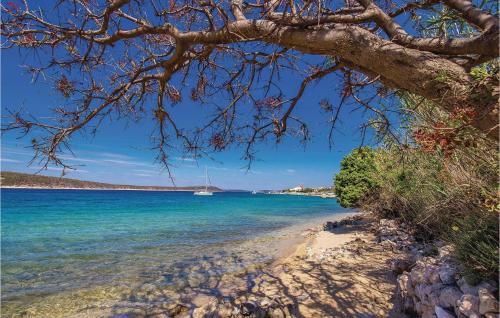 a view of a beach with a boat in the water at Cozy Apartment In Barbat-Rab With Wifi in Barbat na Rabu