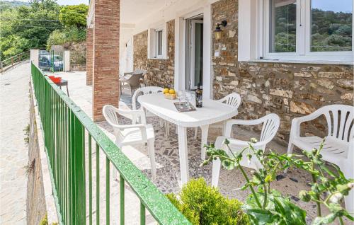 a white table and chairs on the balcony of a house at Pet Friendly Home In Montecorice in Montecorice