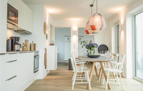 a kitchen and dining room with a table and chairs at Penthouse Comfort in Lembruch