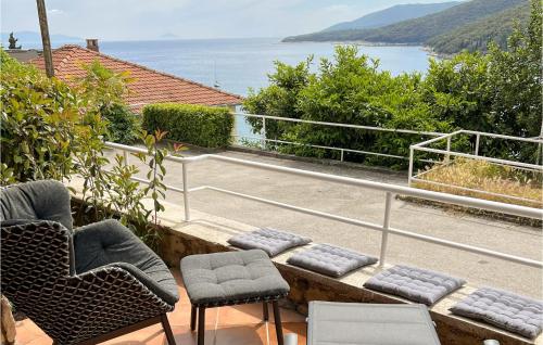 a balcony with chairs and a view of the water at Apartment Rudarska V in Rabac