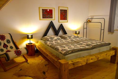 a bedroom with a wooden bed and a chair at Osada Dzikie Wino in Budzów