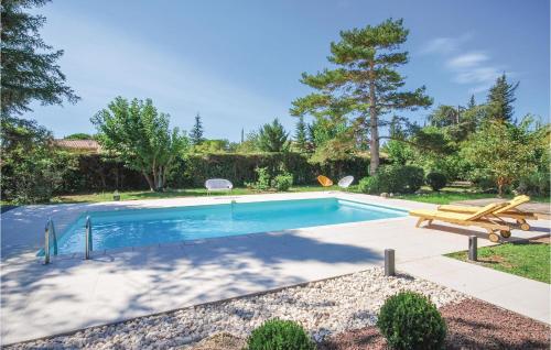 a swimming pool in a yard with a picnic table and a bench at Stunning Home In Fayence With Wifi in Fayence