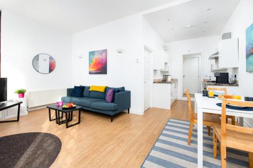 a living room with a couch and a table at Large 1 bed Flat-Long Stays-By MatchstickStays in Bristol