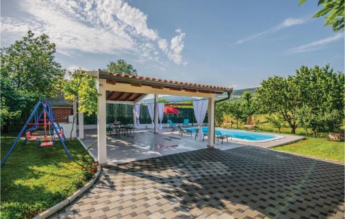 a backyard with a pavilion and a pool at Three-Bedroom Holiday Home In Prolozac Donji in Donji Proložac