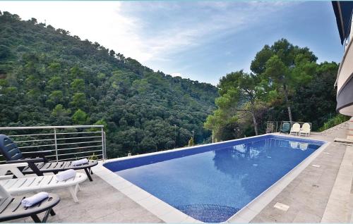 a swimming pool with a view of a mountain at Lovely Home In Santa Susanna With Wifi in Santa Susanna