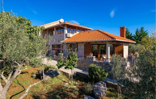 a house with a roof on a hill with trees at Gorgeous Home In Zgaljici With Sauna in Žgaljić