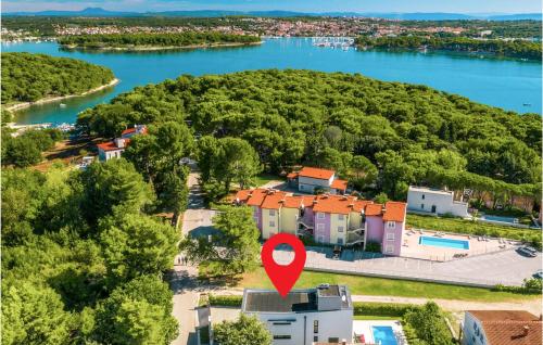 an aerial view of a house with a red marker at Four-Bedroom Holiday Home In Premantura in Premantura