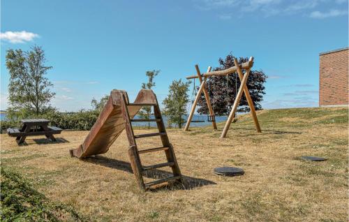 a playground with a ladder and a swing set at Stunning Home In Knebel With Sauna in Knebel