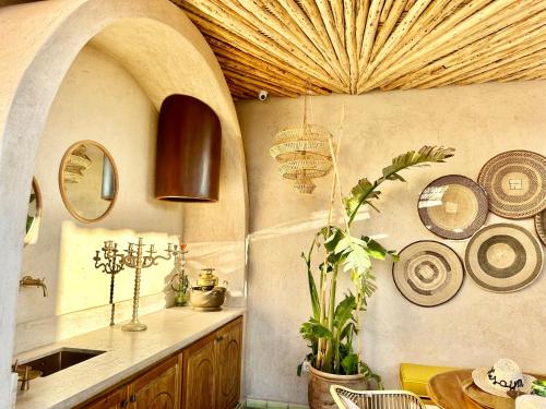 a kitchen with a table and plates on the wall at Riad Nesayam in Marrakech