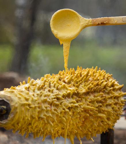 a hedgehog with a spoon pouring honey on it at Sodyba Ignė in Druskininkai