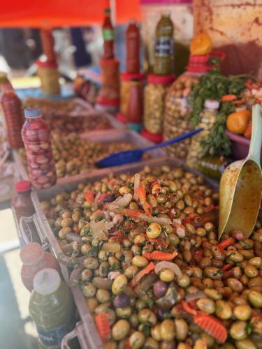 a display of olives and other vegetables on a table at Villa Manzar piscine chauffée in Essaouira