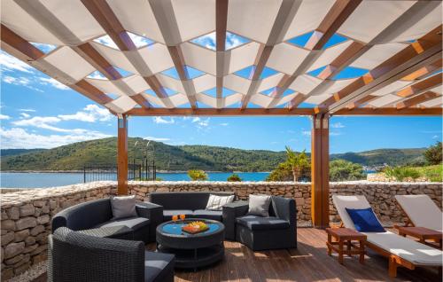 a patio with furniture and a view of the water at Nice Home In Vis With Kitchen in Vis