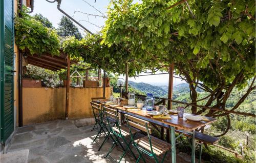 a wooden table and chairs on a patio with trees at 3 Bedroom Stunning Home In Marliana in Marliana