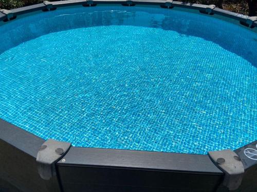 a large pool with blue water in it at Villa SPA Proche Ardeche Ruoms-Vallon pont d'Arc et sites in Ruoms