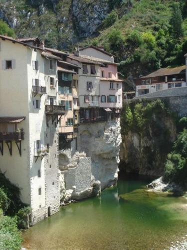 a group of buildings on the side of a river at Chez Marie in Pont-en-Royans