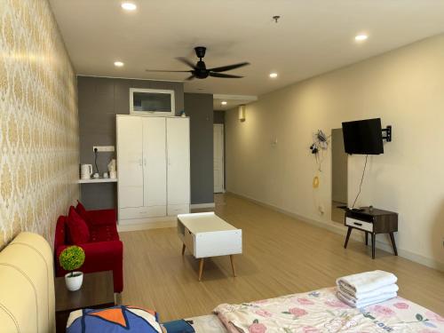 a living room with a couch and a ceiling fan at KF Homestay Premium Suite in Kampar
