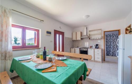 a kitchen with a table with a green table cloth at Apartment Krnica Iv in Krnica