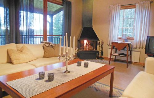 a living room with a couch and a table with candles at Gorgeous Home In Gislaved With Wifi in Våthult