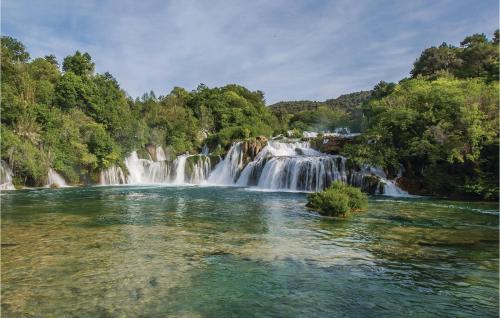 a waterfall in the middle of a river at Two-Bedroom Holiday Home In Kijevo in Kijevo
