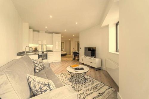 a living room with a couch and a table at Stylish studio apartment in Olton