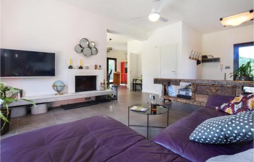 a living room with a purple couch and a fireplace at Gorgeous Home In Trabia With Wifi in Trabia