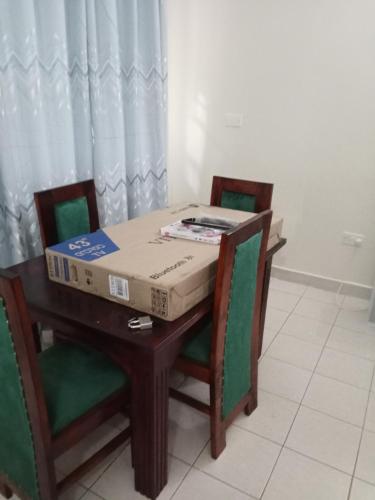 a pizza box sitting on top of a table at Miles haven in Kakamega