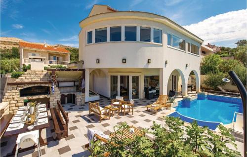 a house with a swimming pool and a patio at Luxurious Home In Pag in Pag