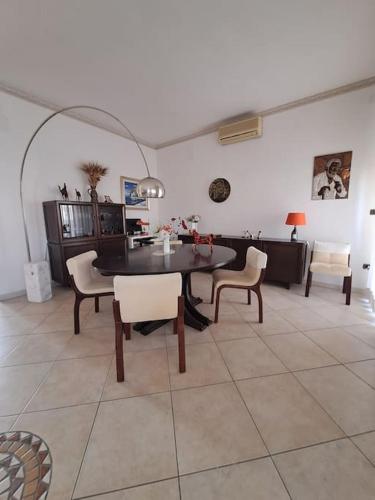 a dining room with a table and some chairs at 2 Giugno House in Bari