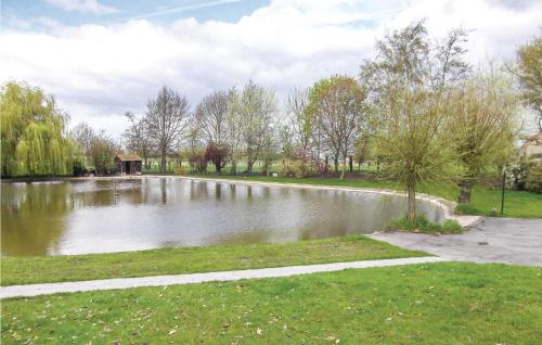 a pond in a park with trees and grass at Six-Bedroom Holiday Home In Lo-Reninge in Lo-Reninge