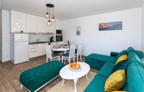 a living room with a blue couch and a table at 3 Bedroom Nice Apartment In Komarna in Komarna