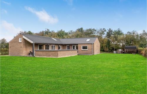 a house with a large lawn in front of it at 4 Bedroom Awesome Home In Vinderup in Vinderup
