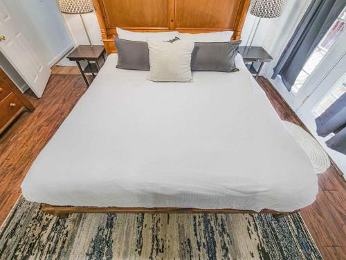 a large white bed with a wooden headboard in a room at NEW LISTING Sasquatch Lodge F in Gatlinburg