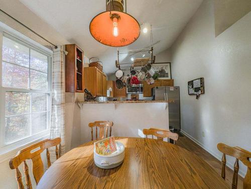 a dining room with a wooden table and a kitchen at NEW LISTING Sasquatch Lodge F in Gatlinburg