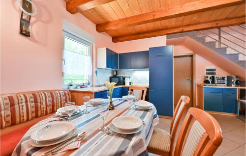 a kitchen and dining room with a table and chairs at Amazing Home In Susobreg With Wifi in Jertovec