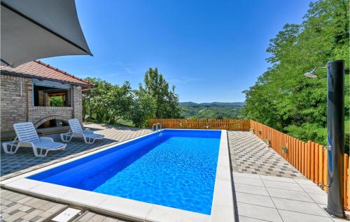 a swimming pool in the backyard of a house at Amazing Home In Susobreg With Wifi in Jertovec