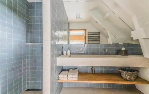 a bathroom with a sink and blue tiles at Cozy Home In Blancafort in Blancafort