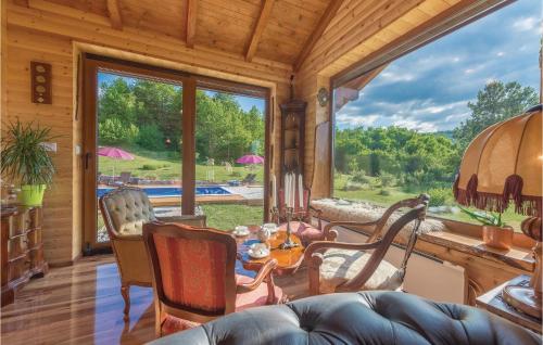 un soggiorno con tavolo e sedie e una grande finestra di Stunning Home In Gospic With Wifi a Gospić