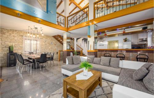 a living room with a couch and a table at 3 Bedroom Amazing Home In Smoljanci in Smoljanci