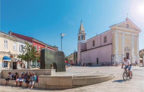 a group of people sitting around a fountain in a street at Studio Apartment In Svlovrec in Jakići