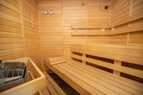 a wooden sauna with two wooden benches in it at Parkhotel Skalní město in Jičín