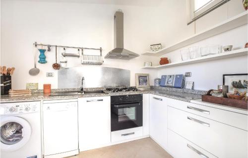 a white kitchen with a stove and a dishwasher at S Rocco Dimora Tra Ulivi E M in Zoagli