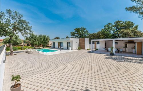 a house with a patio and a swimming pool at Beautiful Home In Biograd With Wifi in Biograd na Moru