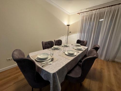a dining room table with chairs and a table cloth at Apartment in the Villa Northern Dreams #2 PARKING INCLUDED IN PRICE in Timişoara