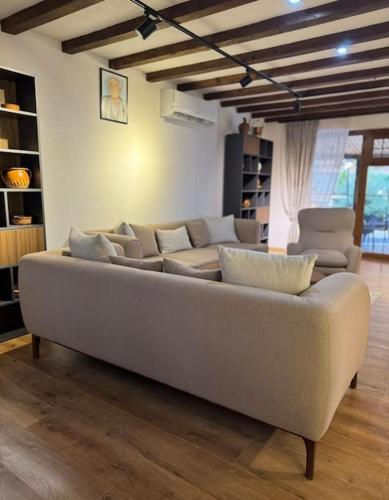 a living room with a large couch and chairs at Villa Lumi 1 in Brezovicë