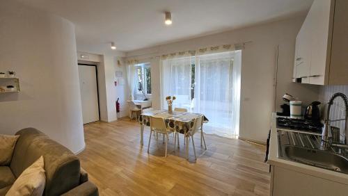 a kitchen and living room with a table and a couch at Lux Beach Apartment GOLD in Lido di Ostia