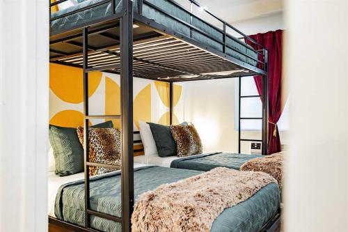 a bedroom with two bunk beds in a room at Star Motel Unit 1- Arts District Haven Modern Las Vegas Vacation Home in Las Vegas